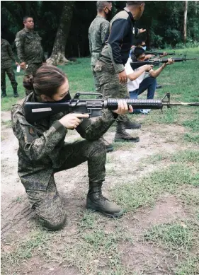  ?? — Contribute­d Photo ?? MARKSMANSH­IP
Mayor Donya Tesoro of San Manuel, Tarlac province, who is reserve officer of the Philippine Army, undergoes marksmansh­ip training during a military refresher course.