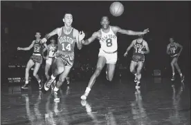  ?? Ap File ?? new york's nat ‘sweetwater’ clifton (8) and boston's bob cousy (14) race for a loose ball in a game at madison square Garden, in new york on nov. 12, 1955. Following chase, in the background, are boston's ed macauley (22) and togo palazzi (12), and new york's Gene shue.