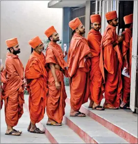  ?? REUTERS ?? Monks stand in a queue to cast their votes at a polling station during the last phase of the Gujarat Assembly elections on the outskirts of Ahmedabad, on Thursday.