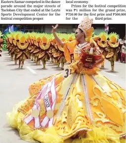  ??  ?? FESTIVAL OF FESTIVALS – With the image of the Sto. Niño de Tacloban, patron saint of Leyte, in her arms, a member of the Sanggutan Festival from Barugo, Leyte dances during the 32nd Pintados-23rd Kasadyaan Festival in Tacloban City yesterday. (Nestor...