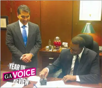  ??  ?? Atlanta Mayor Kasim Reed signs a marriage equality resolution introduced by City Councilmem­ber Alex Wan (left), who is gay. (Photo by Sonji Jacobs)