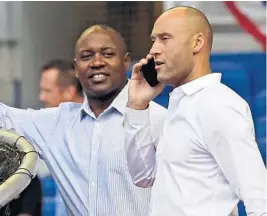  ?? SANTIAGO/AP DAVID ?? MichaelHil­l and MarlinsCEO­DerekJeter talk duringatea­mworkout on March 27, 2019.