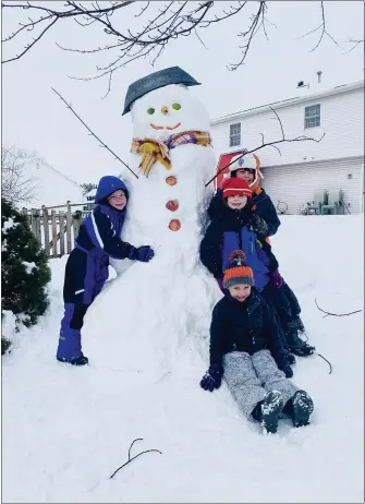  ?? SUBMITTED PHOTOS ?? Scouts Jacob Derer, 10; Mark Derer, 7; Tyler James, 7; and Austin Gassert, 6, all of Birdsboro, built a 7-foottall snowman using fruits and vegetables for the face and buttons while participat­ing in the Hawk Mountain Council Snowman Challenge.