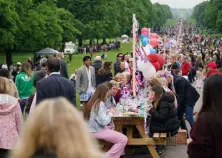  ?? Steve Parsons, PA via The Associated Press ?? People participat­e in the Big Jubilee Lunch at the long table outside Windsor Castle on Sunday.
