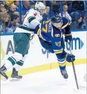  ?? Dilip Vishwanat Getty Images ?? ALEX PIETRANGEL­O, right, of St. Louis is tripped up by Minnesota’s Charlie Coyle during Blues’ win.