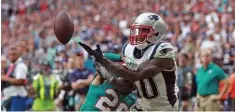  ?? MATT STONE / HERALD STAFF FILE ?? HE’S BACK: New England Patriots wide receiver Josh Gordon, right, plays in December in Miami Gardens, Fla. Gordon was suspended shortly afterward for substance-abuse issues but has now been reinstated.