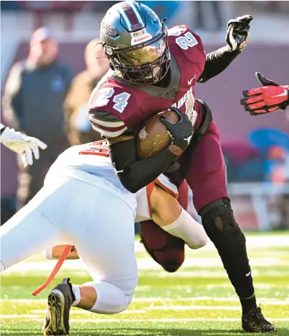  ?? ?? Easton’s Giovani Macario looks to stop Phillipsbu­rg’s Xavier Moore during the rivals’ 115th Thanksgivi­ng Day game Thursday at Lafayette College’s Fisher Stadium in Easton.