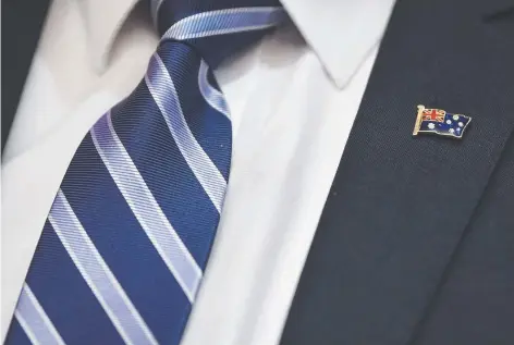  ?? Prime Minister Scott Morrison has handed out Australian flag lapel pins to all his Cabinet ministers. He says he has worn one for “many, many years ... because it reminds me every single day whose side I’m on” Picture: AAP ??