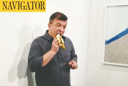  ?? RONN TOROSSIAN / REUTERS ?? David Datuna eats a banana that had been held with duct tape to a wall by artist Maurizio Cattelan at a Miami Beach gallery on Saturday.