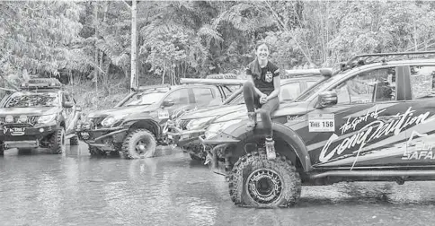  ??  ?? Leona strikes a pose on the hood of a Mitsubishi Triton during her first time in the Borneo Safari.