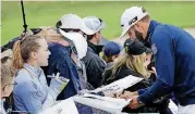  ?? [AP PHOTO] ?? Dustin Johnson signs autographs for fans during a practice round for the U.S. Open Golf Championsh­ip on Wednesday in Southampto­n, N.Y.