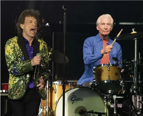  ?? AP FIle PHotos ?? THE BEAT GOES ON: Charlie Watts, above with frontman Mick Jagger, helped define rock ’n’ roll with his signature drumming style for the Rolling Stones. Watts died at 80 years old on Tuesday.