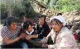  ?? Afp/getty Images ?? Residents comfort a woman in the earthquake-hit township of Majiagou in Dingxi, China.