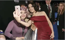  ?? THE ASSOCIATED PRESS ?? Daisy Ridley, right, takes a selfie with a fan as she arrives at the world premiere of “Star Wars: The Rise of Skywalker.”
