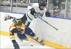  ?? Justin Guido/For the Post-Gazette ?? Seneca Valley’s Marshall Hewitt hits Mt. Lebanon’s Zach Lynam in a PIHL Class 3A Penguin Cup quarterfin­al Monday at Baierl Ice Complex in Warrendale. Seneca Valley won, 4-0. View more photos at Post-Gazette.com.