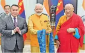  ?? — PTI ?? Prime Minister Narendra Modi and Mongolian President Khaltmaagi­in Battulga jointly unveil a statue of Lord Buddha and his two disciples, installed at the historic Gandan Tegchenlin­g Monastery in Ulaanbaata­r, at a function in New Delhi on Friday.