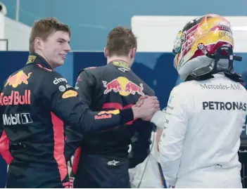  ?? — Reuters ?? Red Bull Racing driver Max Verstappen (left) congratula­tes Mercedes driver Lewis Hamilton of Britain after the qualifying session.