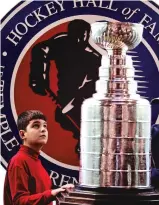  ?? ASSOCIATED PRESS FILE PHOTO ?? Jonathan Acica of Montreal looks up at the Stanley Cup in 2005 at the Hockey Hall of Fame in Toronto. The abandoned 1919 finals was just one of two instances since 1893 that the championsh­ip trophy was not awarded. The only other time no champion was crowned was when the 2005 lockout wiped out the entire NHL season.