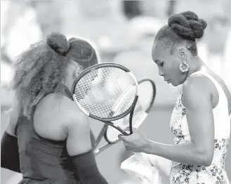  ?? AGENCE FRANCE PRESSE ?? Venus Williams of the United States walks past Serena Williams of the United States in their match during the BNP Paribas Open at the Indian Wells Tennis Garden in Indian Wells, California.