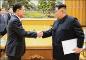  ?? THE BLUE HOUSE ?? South Korean envoys meet Monday with North Korean leader Kim Jong Un (right) in Pyongyang, the North Korean capital. Kim said his country is willing to talk with the U.S. on abandoning its nuclear weapons.