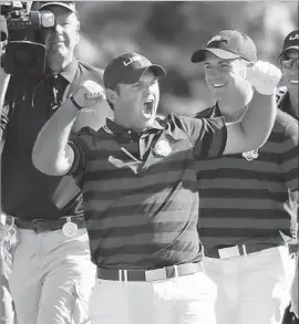  ?? Brian Peterson Minneapoli­s Star Tribune ?? PATRICK REED IS FIRED UP after holing out for an eagle on the sixth hole during the afternoon four-balls. Partner Jordan Spieth is all smiles behind him.