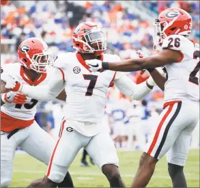  ?? Joe Robbins / Getty Images ?? Lorenzo Carter (7) of the Georgia Bulldogs celebrates with teammates after a sack against the Florida Gators in the first quarter of a game at EverBank Field on Oct. 28, 2017 in Jacksonvil­le, Fla.