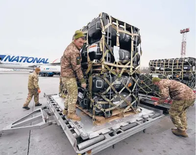  ?? SERGEI SUPINSKY/GETTY-AFP ?? Ukrainian soldiers receive Javelin missiles from the U.S. on Feb. 11 in Kyiv. Russia invaded Ukraine 13 days later.