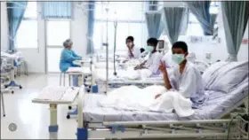  ?? THAILAND GOVERNMENT SPOKESMAN BUREAU VIA AP ?? Three of the 12 boys are seen recovering in their hospital beds after being rescued along with their coach from a flooded cave in Mae Sai, Chiang Rai province, northern Thailand.