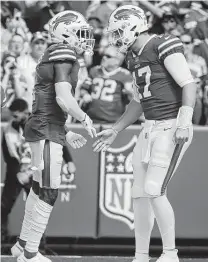  ?? Jeffrey T. Barnes / Associated Press ?? Bills receiver Emmanuel Sanders, who had five catches and two touchdowns Sunday, celebrates a score with Josh Allen, right.