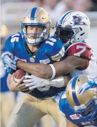  ?? PAUL CHIASSON/THE CANADIAN PRESS FILES ?? Bombers quarterbac­k Matt Nichols is sacked by Alouettes defensive end John Bowman during last Thursday’s CFL action in Montreal. Bowman leads the team with five sacks.