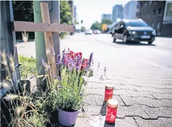  ?? FOTO: DPA ?? Ein Kreuz nahe der Unfallstel­le in Mönchengla­dbach soll an das Opfer des illegalen Rennens erinnern. Ein 38-jähriger Mann war dort von einem Autofahrer erfasst worden, der sich mit anderen Pkw ein Rennen geliefert haben soll.
