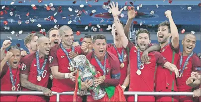  ?? AP PHOTO ?? Cristiano Ronaldo holds the trophy after Portugal won the Euro 2016 final over France at the Stade de France in Saint-Denis, north of Paris, Sunday.