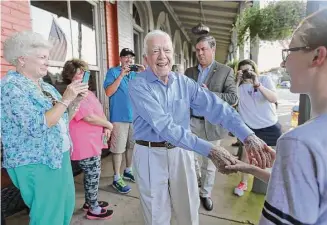  ?? Ben Gray/TNS file photo ?? President Jimmy Carter shakes hands as he arrives at a birthday party for his wife Rosalynn in 2015 in Plains, Ga.