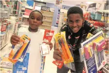  ?? JACQUES NAUDE African News Agency (ANA) ?? KHOLOFELO Masufi, 9, and his brother Tolerance, 15, get their school stationery at CNA in the Hatfield Mall in Tshwane. Kholofelo is set to start Grade 3 and Tolerance Grade 10 at Crawford College. |