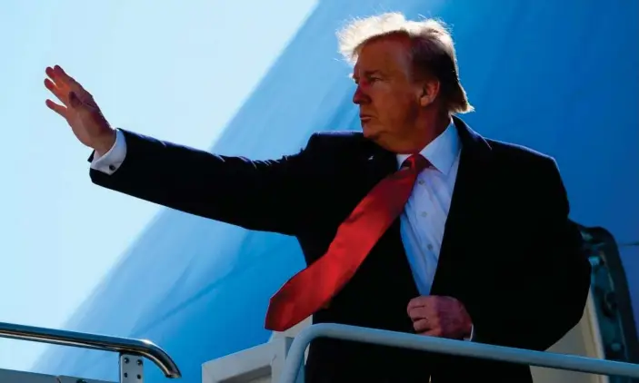  ?? Photograph: Andrew Caballero-Reynolds/AFP via Getty Images ?? Donald Trump waves as he boards Air Force One at John F Kennedy airport in New York City.