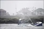  ?? ANNIE RICE — CORPUS CHRISTI CALLER-TIMES VIA AP ?? A boat sinks in the Packery Channel during Hurricane Hanna July 25 in North Padre Island, Texas. The Category 1 storm continued to strengthen before reaching Padre Island at 5 p.m. Saturday.