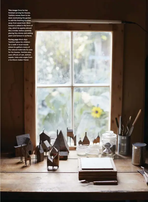  ??  ?? This image Once he has finished carving his houses, Yukihiro moves them to his desk overlookin­g the garden to add the finishing touches away from wood dust. More texture is added in the form of clay, which he applies almost like a render, before carefully placing tiny stones and adding paint and texture to surfaces.
Facing page Most days Yukihiro takes his children for a walk in local woods where he gathers many of the natural materials he uses for his houses. Yukihiro also uses offcuts of oak, walnut, sapele, iroko and maple from a furniture-maker friend.