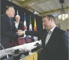  ??  ?? Alberta Premier Jason Kenney, right, shakes hands with his Quebec counterpar­t, François Legault, Thursday
at a meeting of Canada’s premiers in Saskatoon.