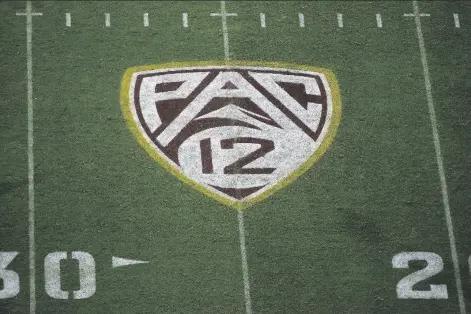  ?? ASSOCIATED PRESS ?? IN THIS AUG. 29, 2019, FILE PHOTO, the Pac-12 logo is displayed on the field at Sun Devil Stadium during an NCAA college football game between Arizona State and Kent State in Tempe, Ariz. As the wealthiest conference­s like the Pac-12 lay out plans they hope will protect athletes from contractin­g and spreading COVID-19, most of the schools in the second-tier of Division I football have given up on trying to play in the fall.
