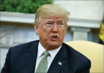  ?? EVAN VUCCI — THE ASSOCIATED PRESS FILE ?? President Donald Trump talks with reporters during a meeting in the Oval Office of the White House in Washington. A former Playboy model who claimed she had an affair with President Donald Trump is seeking to invalidate an agreement that prohibited her...