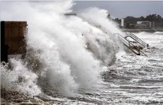  ?? CRAIG RUTTLE/AP ?? Waves pound the seawall in Montauk, N.Y., as Tropical Storm Henri blows in Sunday. The weekend was the wettest two-day period in New York City since Tropical Storm Irene a decade ago.