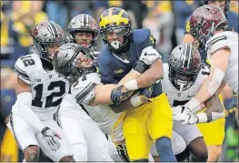  ?? [ADAM CAIRNS/DISPATCH] ?? Nick Bosa brings down Michigan running back Chris Evans in a first quarter that saw the Wolverines gain 105 yards. They totaled just 190 the rest of the game.