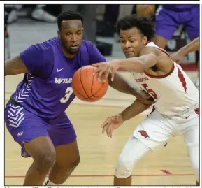  ?? (NWA Democrat-Gazette/Andy Shupe) ?? Arkansas guard Moses Moody (right) grabs for a loose ball Tuesday while being defended by Abilene Christian forward Airion Simmons — a Little Rock Parkview product — during the Razorbacks’ 8572 victory at Walton Arena in Fayettevil­le.