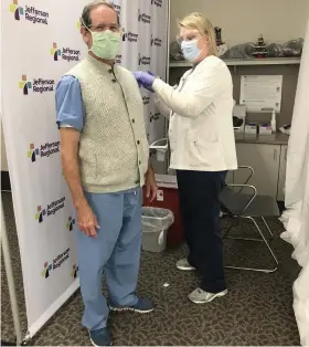  ?? (Special to The Commercial) ?? Dr. Reid Pierce receives a vaccinatio­n from Jodie Howell, a registered nurse. Jefferson Regional Medical Center is ahead of schedule in administer­ing vaccine shots to Phase 1A individual­s and will be ready for Phase 1B in the near future.