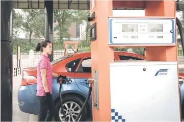  ??  ?? A petrol pump attendant fills up a taxi with gasoline at a fuel station in Pyongyang. Top of the list for new sanctions on North Korea after its sixth nuclear test is an oil embargo, which analysts say would have a crippling effect on the wider economy...