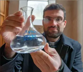  ?? Photograph: Iain Ferguson, alba.photos ?? Father Stan with the small flask which he only fills three times a week at a cost of several hundred pounds.