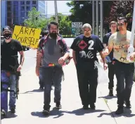  ??  ?? Gun advocates peacefully march through the city streets of Stamford.