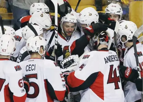  ?? MICHAEL DWYER/THE ASSOCIATED PRESS FILE PHOTO ?? Senators teammates surround Clarke MacArthur after he scored in overtime during the playoffs in April. Medical issues raise questions about his future.