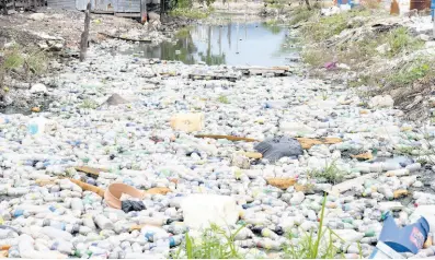  ?? FILE ?? A section of a waterway that is filled with plastic bottles.