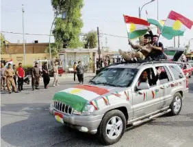  ?? Ansa ?? Timore del contagio Indipenden­tisti curdi a Kirkuk; a sinistra, Massoud Barzani, presidente della regione autonoma